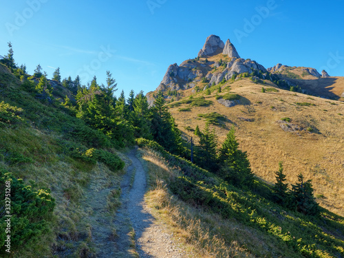 Fototapeta Naklejka Na Ścianę i Meble -  Beautiful morning landscape with a trail to the mountain peak