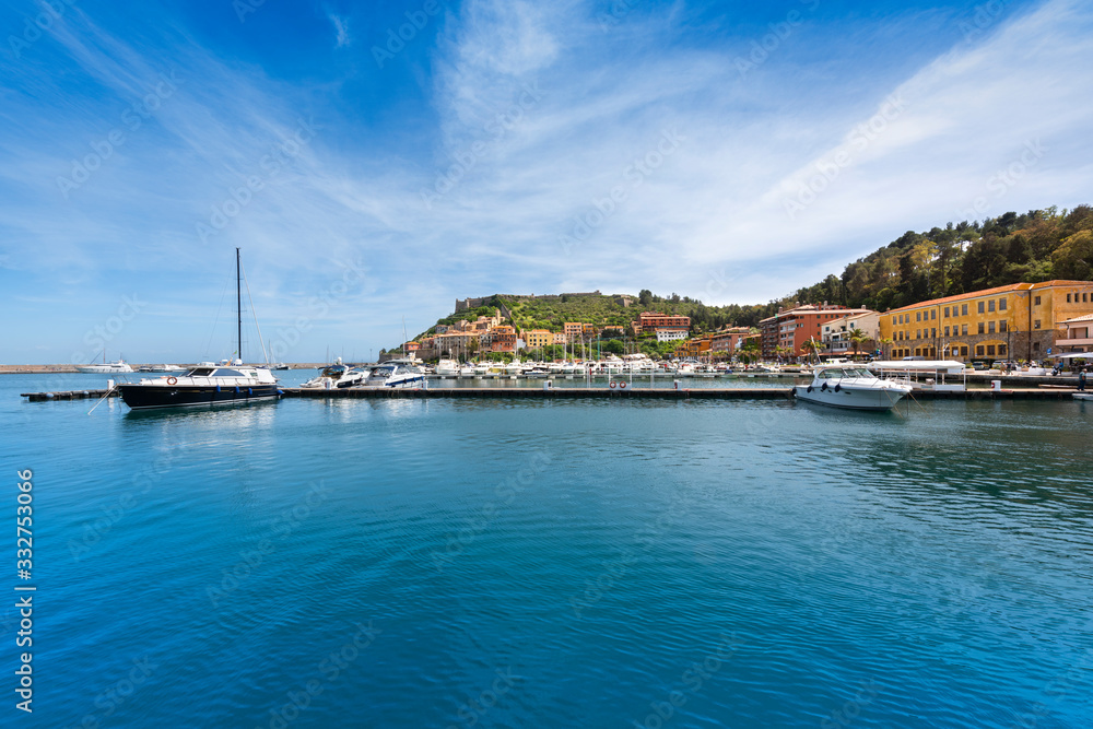 Fototapeta premium Porto Ercole village and boats in the harbour. Monte Argentario, Maremma Grosseto Tuscany, Italy