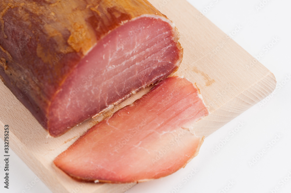 Delicious smoked meat on a wooden board isolated on white background.Copy space Delicious smoked meat on a wooden board isolated on white background.Copy space