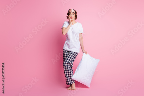 Full length photo of pretty lady hold pillow watch sale shopping advertisement wear sleep mask white t-shirt checkered pajama pants barefoot isolated pink color background