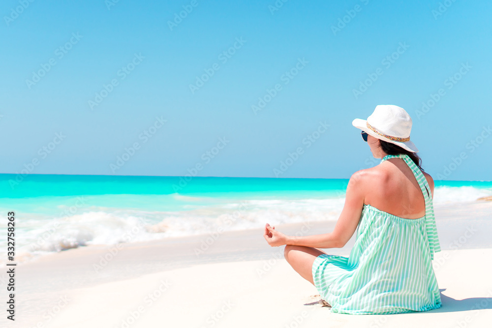 Woman laying on the beach enjoying summer holidays looking at the sea Woman laying on the beach enjoying summer holidays looking at the sea