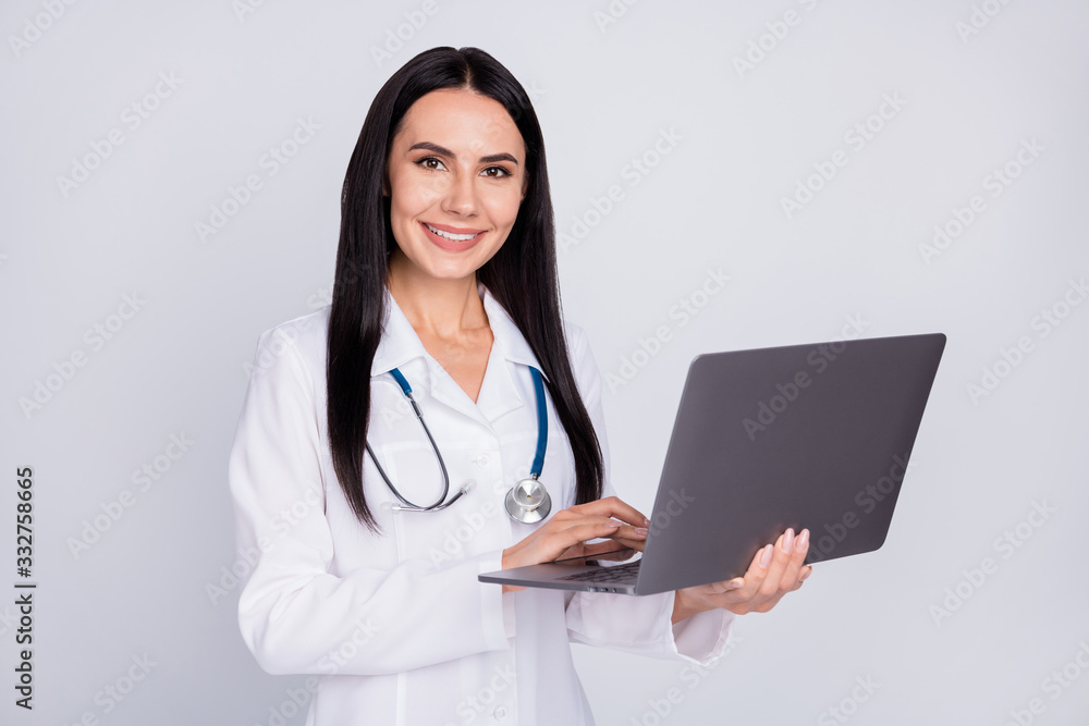Photo of professional doc lady working with modern technology notebook laptop writing notes patient prescription wear stethoscope white lab coat isolated grey color background Photo of professional doc lady working with modern technology notebook laptop writing notes patient prescription wear stethoscope white lab coat isolated grey color background