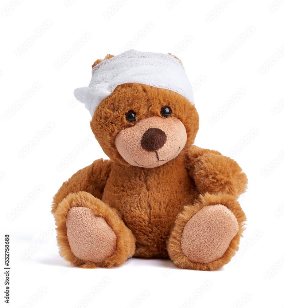teddy bear with a bandaged head in a white medical bandage on a white background teddy bear with a bandaged head in a white medical bandage on a white background