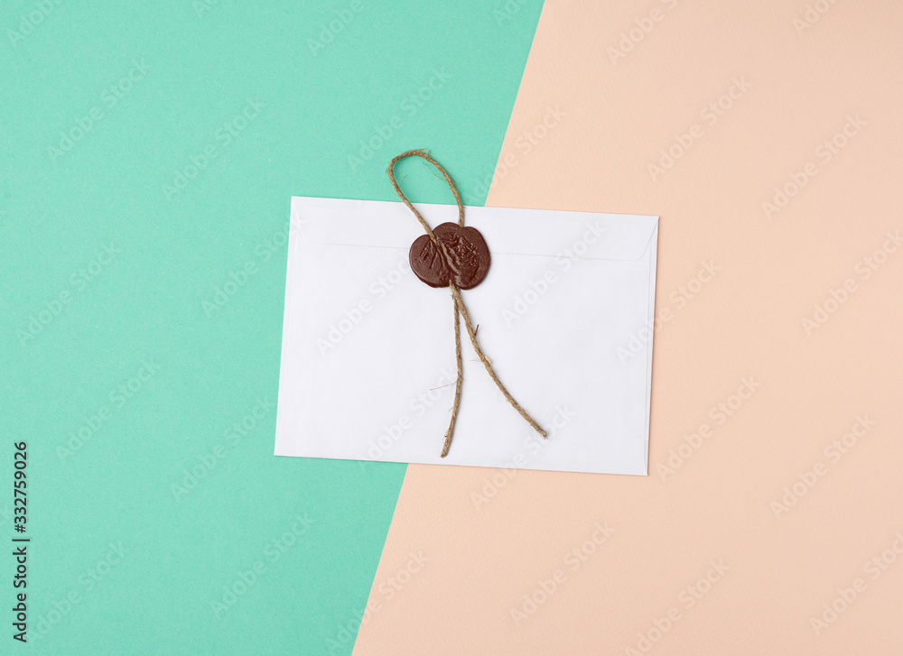 rectangular white paper envelope and brown stamp, color background rectangular white paper envelope and brown stamp, color background