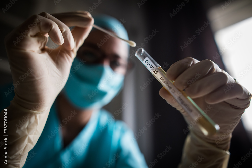 Doctor holding a coronavirus COVID-19 test tube Doctor holding a coronavirus COVID-19 test tube