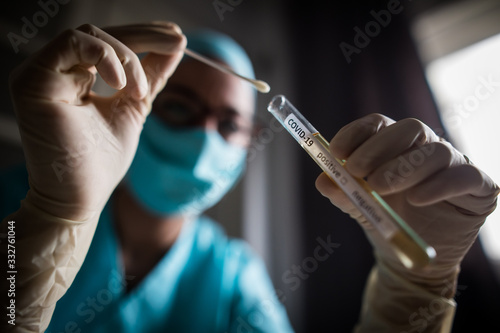 Doctor holding a coronavirus COVID-19 test tube photo