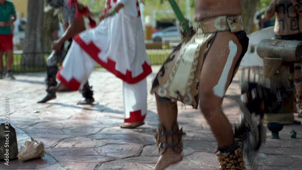 Closeup of Mayan dancers legs performing to live drums outside in a park in Valladolid, Mexico. Closeup of Mayan dancers legs performing to live drums outside in a park in Valladolid, Mexico.