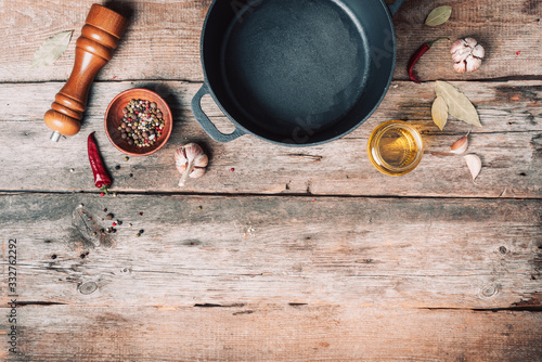 Empty iron pot and kitchen utensils on wooden background. Top view. Copy space. Healthy, clean food and eating concept. Zero waste. Cooking frame