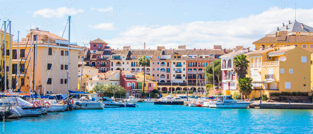 Port Sa Playa, Valencia, Spain - 3/19/2019: Bright sunny day panoramic photo looking at Port Saplaya, Valencia's Little Venice