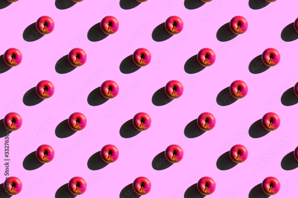 Apples pattern. Creative food on pink background. Fresh season fruit texture with strong shadows Apples pattern. Creative food on pink background. Fresh season fruit texture with strong shadows
