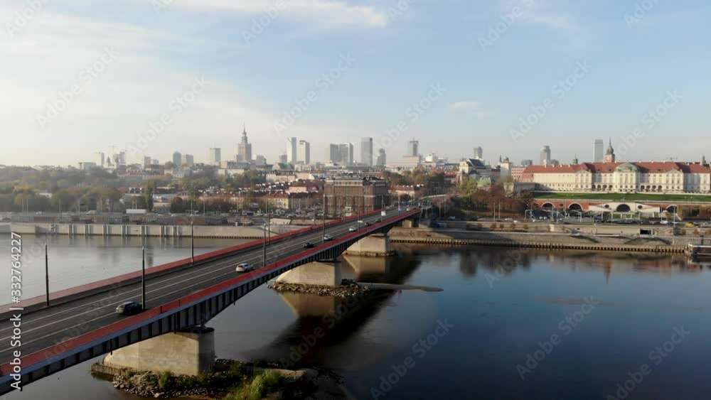 Panoramic aerial shot of Slasko-Dabrowski bridge, downtown and the Royal Castle in Warsaw, Poland at the beautiful, sunny day. Cinematic drone shot of cars, trams and buses passing by the river Panoramic aerial shot of Slasko-Dabrowski bridge, downtown and the Royal Castle in Warsaw, Poland at the beautiful, sunny day. Cinematic drone shot of cars, trams and buses passing by the river