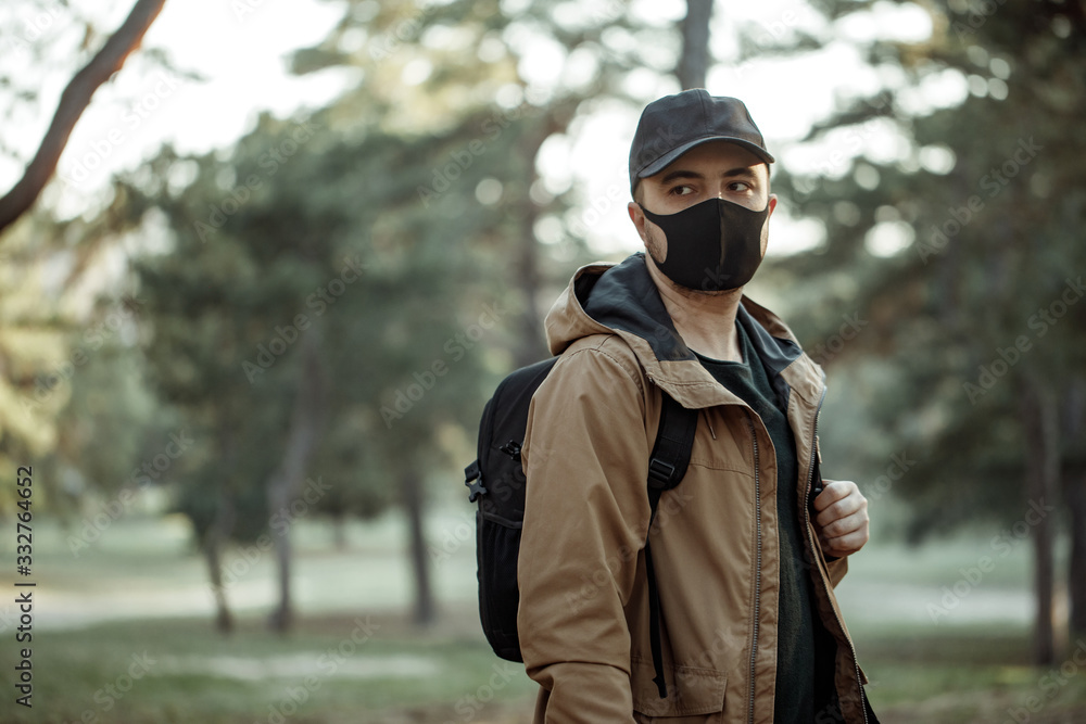 man in medical mask walking in park man in medical mask walking in park