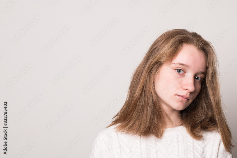 Sad teenager girl. Studio image of a cute young girl on a gray background. Sad teenager girl. Studio image of a cute young girl on a gray background.