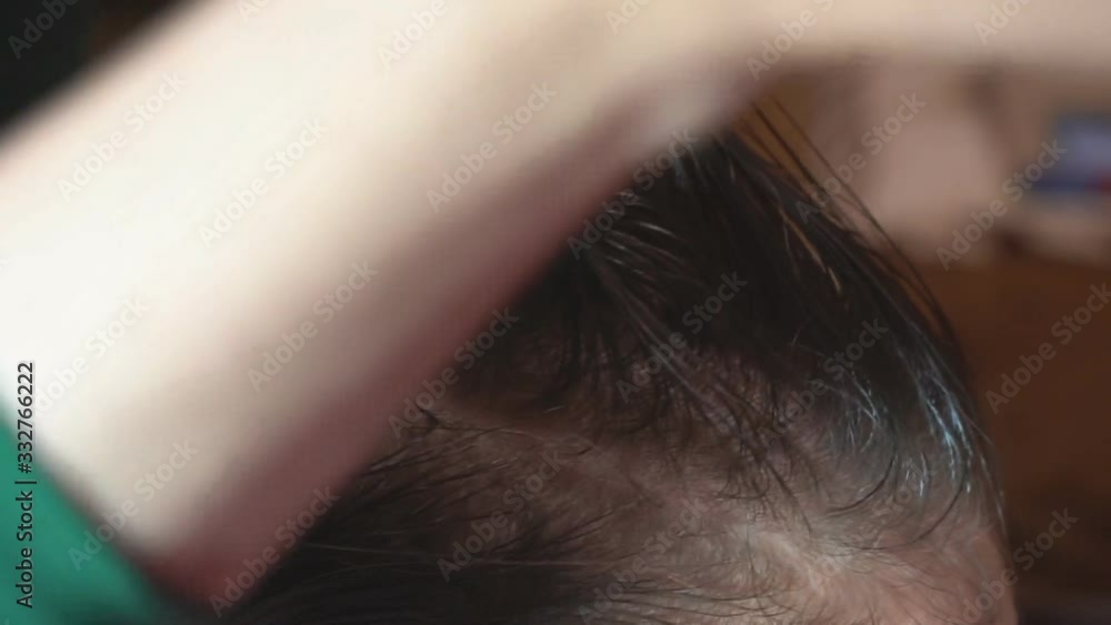 Curl hair on the curl. The hairdresser makes a hairstyle for a child by combing and twisting hair into a curl in a beauty salon. Curl hair on the curl. The hairdresser makes a hairstyle for a child by combing and twisting hair into a curl in a beauty salon.