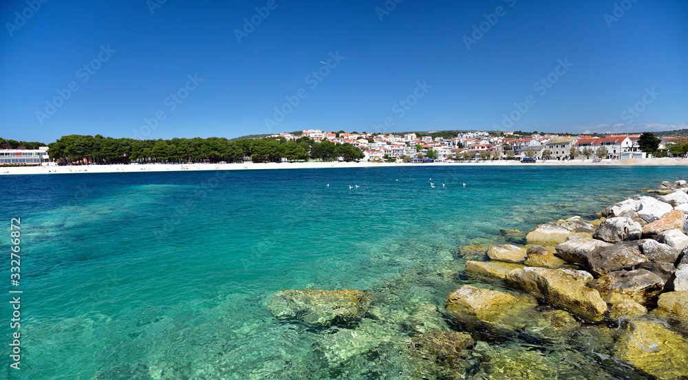 The snow white beach in famous and beautiful Primosten town in Dalmatia - popular tourist destination in Dalmatia. Croatia