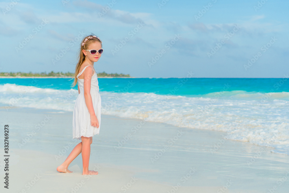 Adorable little girl have fun at tropical beach during vacation Adorable little girl have fun at tropical beach during vacation
