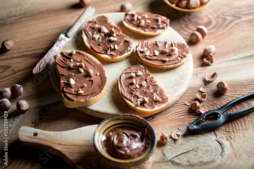 Sandwiches with chocolate cream on wood.