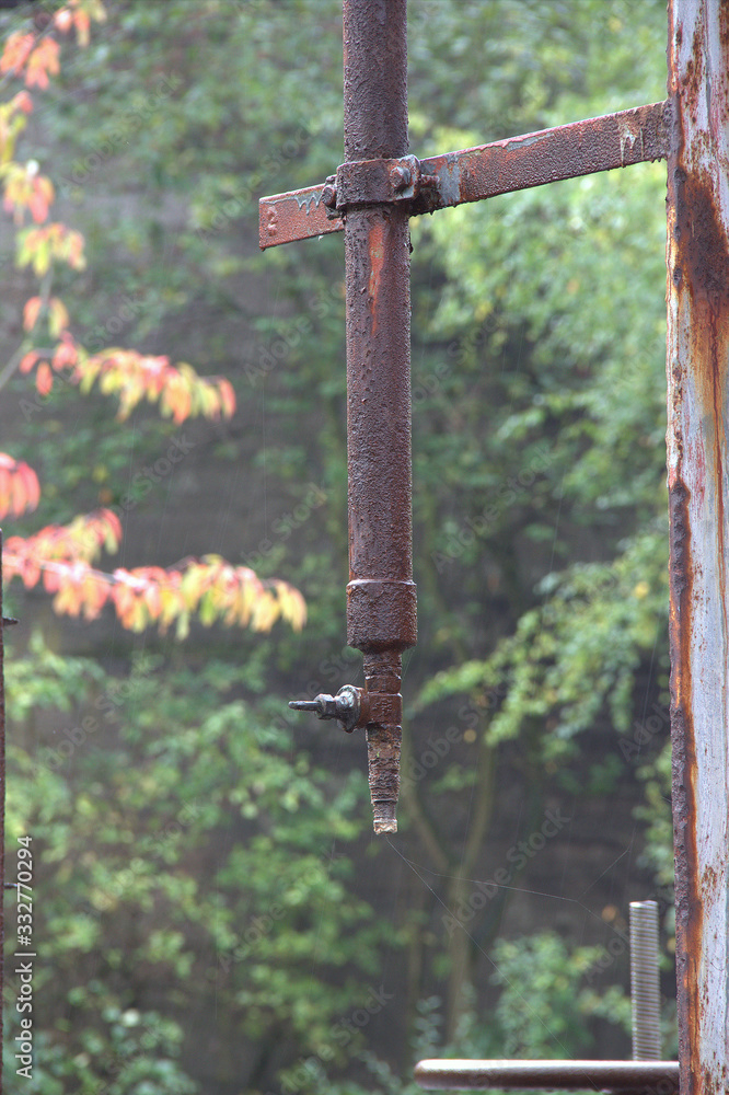 rusted pipeline with shut-off valve in a disused factory rusted pipeline with shut-off valve in a disused factory