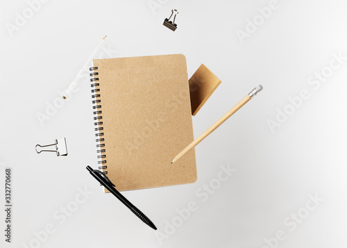 Obraz na płótnie Stationery set. Levitation of notepad, pencils, pen, sticker and binder clips. Copy space on notebook and notes. Writing tools. Office supplies. Isolated on gray backdrop w salonie
