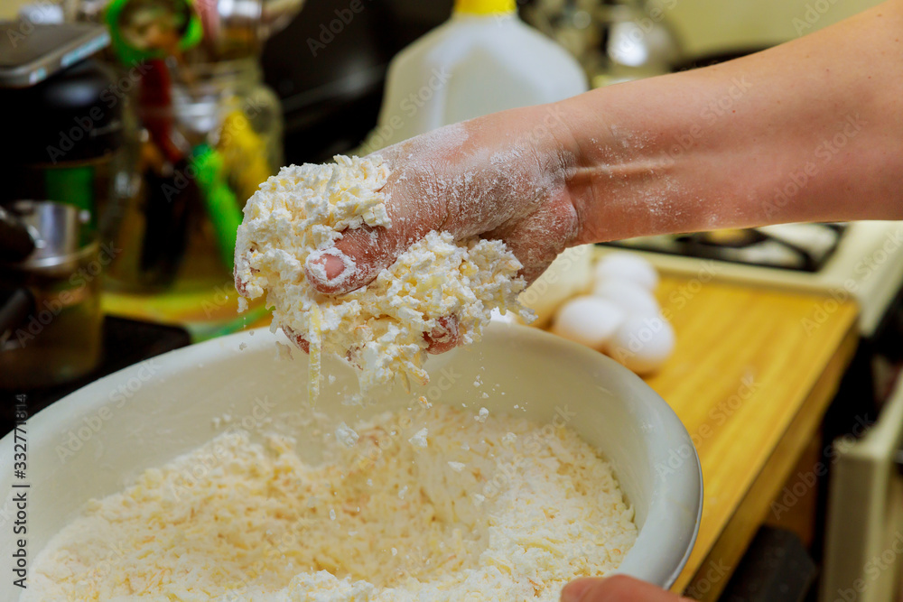 Fototapeta premium Woman making dough for baking cheese bread called chipa.
