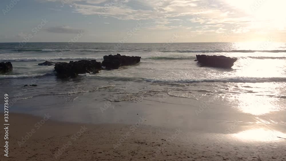 sunset in bali the waves are breaking on the beach the sky is very beautiful sunset in bali the waves are breaking on the beach the sky is very beautiful