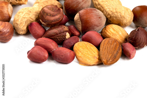 A mixture of peanuts, almonds, hazelnuts on a white background, close-up