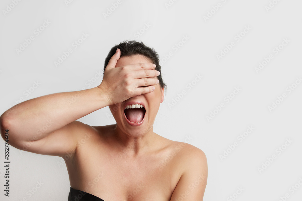 Naklejka premium Dark Hair beautiful woman screaming on the white background. Horizontal.