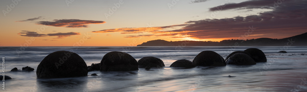 Moeraki Boulders at sunrise with a colourful sky, New Zealand