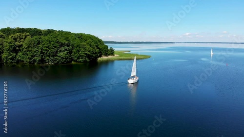 Aerial view of sailboat on the beautiful lake Kisajno on a sunny day. Mazury by drone, Poland photo