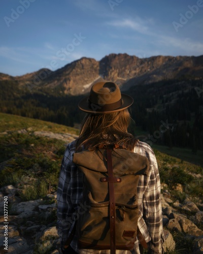 Young Active Female with Pack Takes in the Mountain View