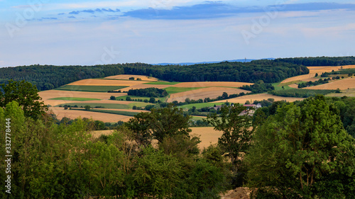 landscape with wheat field and blue sky  view on valley  Jagsttal  in M  ckm  hl  Germany