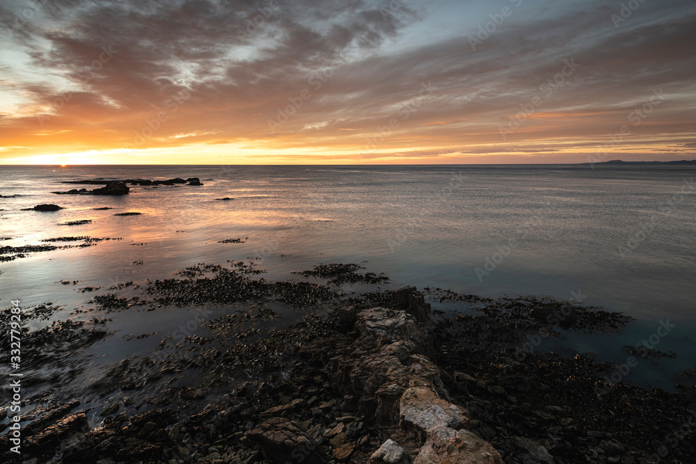Beautiful sunrise on the sea from Shag Point, New Zealand Beautiful sunrise on the sea from Shag Point, New Zealand