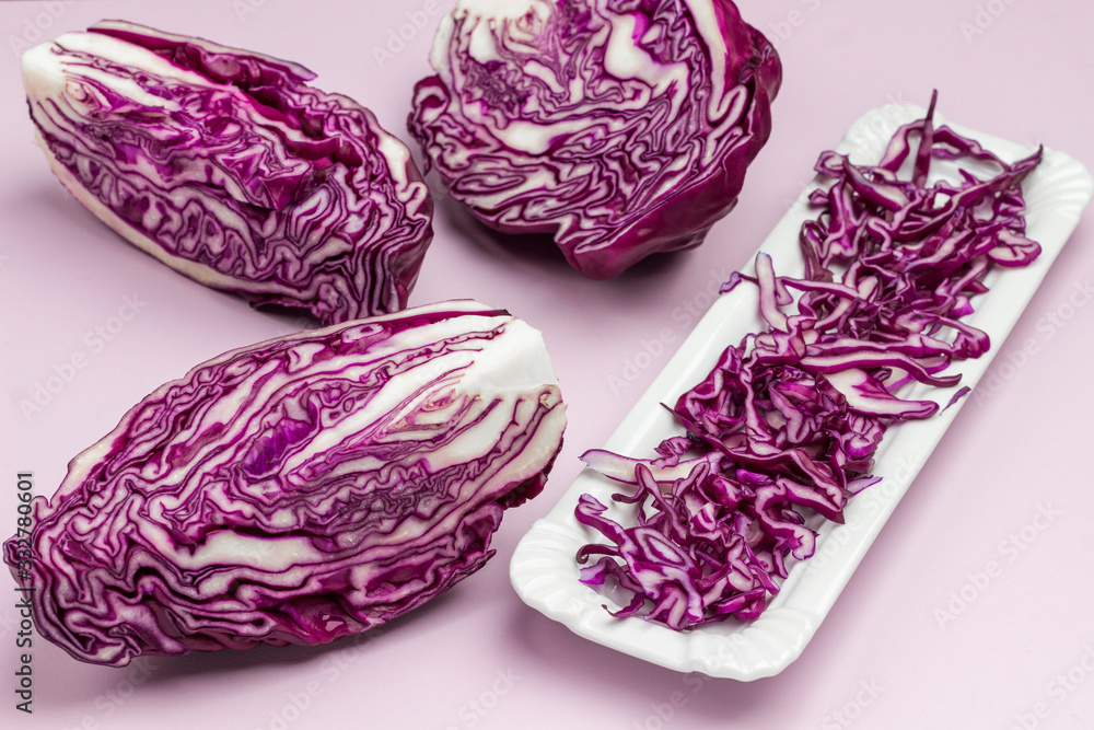 Halved red cabbage, sliced cabbage on on white plate. Halved red cabbage, sliced cabbage on on white plate.