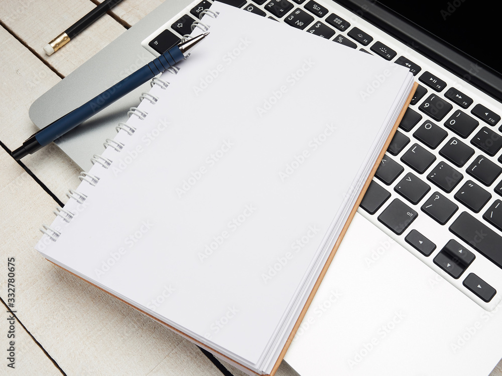 Workplace - laptop, notebook, pen, and pencil for remote work on a white wooden table. Freelance desktop for home or office. Background with copy space. Workplace - laptop, notebook, pen, and pencil for remote work on a white wooden table. Freelance desktop for home or office. Background with copy space.