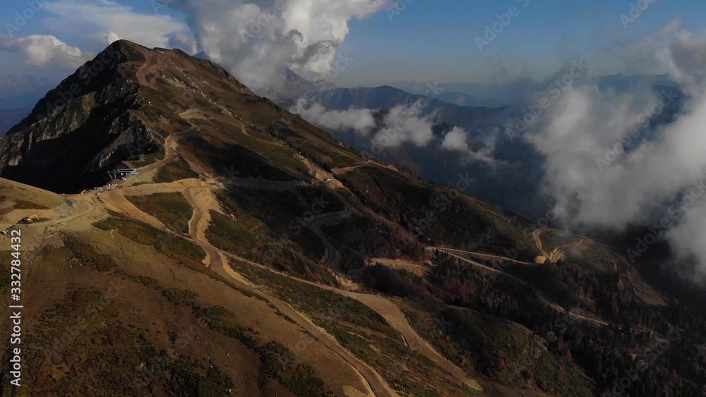 Nice cinematic Aerial view of summit of mountain with clouds at autumn