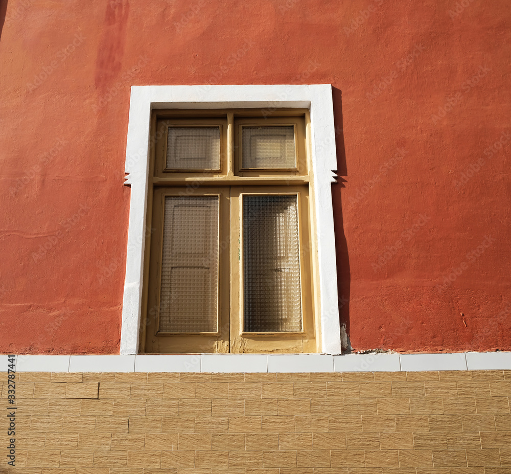 A simple single window in a brown wall. A simple single window in a brown wall.