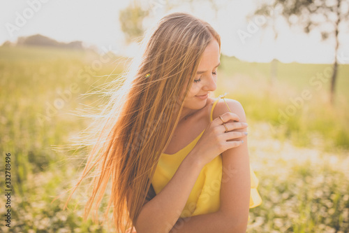 Portrait of young, pretty woman outdoor on a summer sunny day