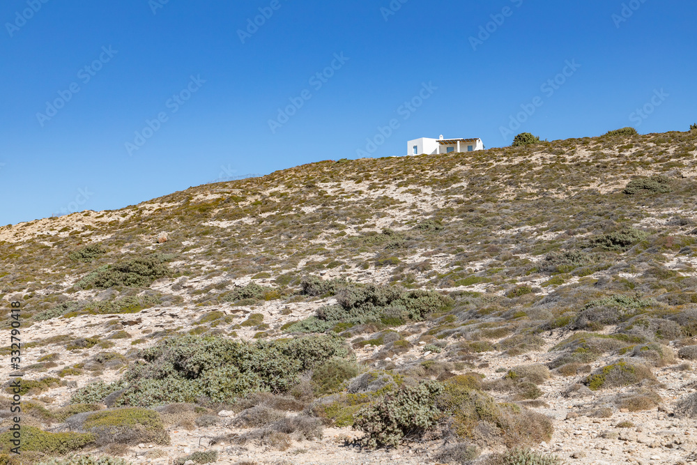 Small house, Rocks and vegetation in Mytakas beach