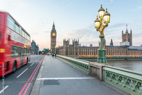 Red Bus speeds up along Westminster Bridge - London, UK
