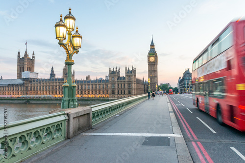 LONDON - JULY 3, 2015: Red Double Decker Bus speeds up along city streets