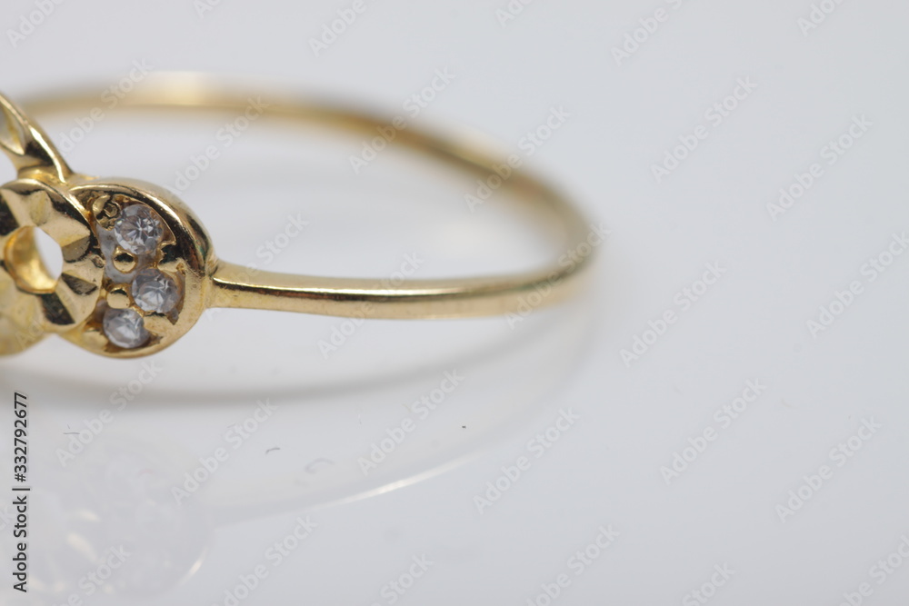 Macro shot of gold ring jewelry on an isolated background Macro shot of gold ring jewelry on an isolated background