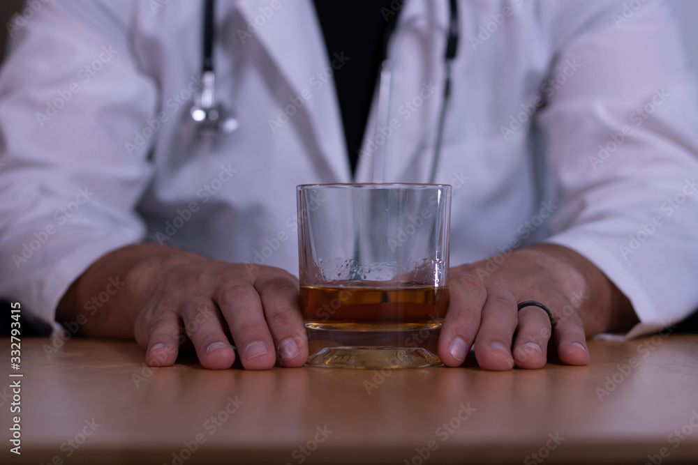 Close-up of doctor hands holding liquor