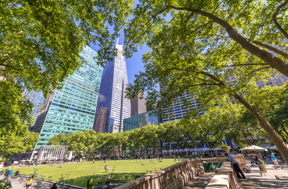 NEW YORK CITY - JUNE 2013: Tourists enjoy Bryant Park in summer season, Manhattan NEW YORK CITY - JUNE 2013: Tourists enjoy Bryant Park in summer season, Manhattan