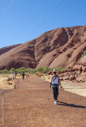 Back view of woman walking along outback trail, Australia