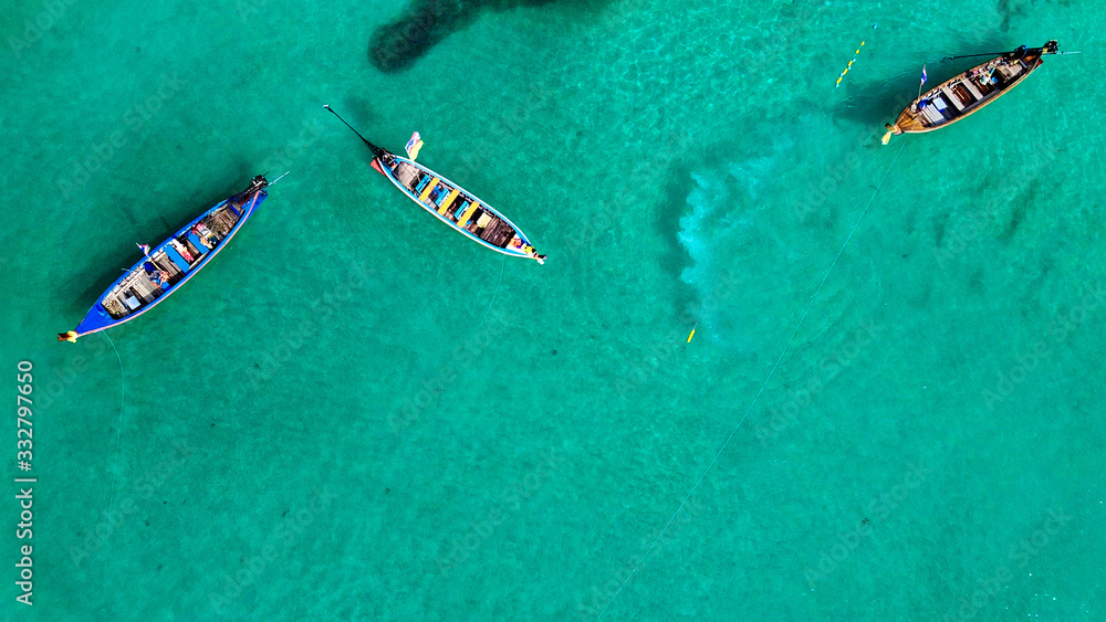 Aerial view of long tail boats along a tropical beach, Thailand Aerial view of long tail boats along a tropical beach, Thailand