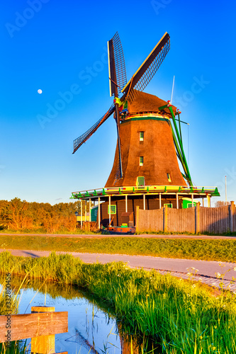 Dutch Travel Concepts. Traditional Dutch Windmill in the Village of Zaanse Schans at Daytime in the Netherlands. photo