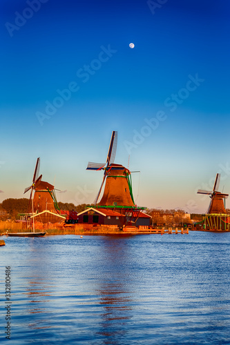 Dutch Travel Concepts. Three Traditional Dutch Windmills in the Village of Zaanse Schans at Daytime in the Netherlands. photo