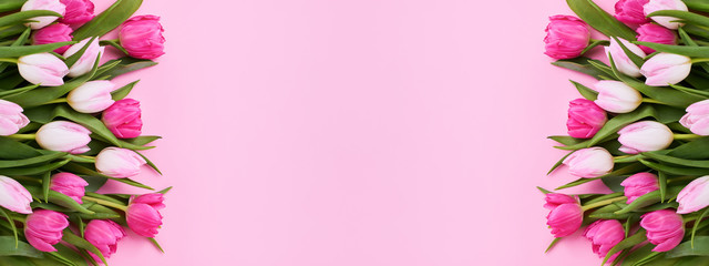 Pink Holiday banner. Bouquet of pink tulips on pink background. Mothers day, Valentines Day, Birthday celebration concept. Copy space, top view