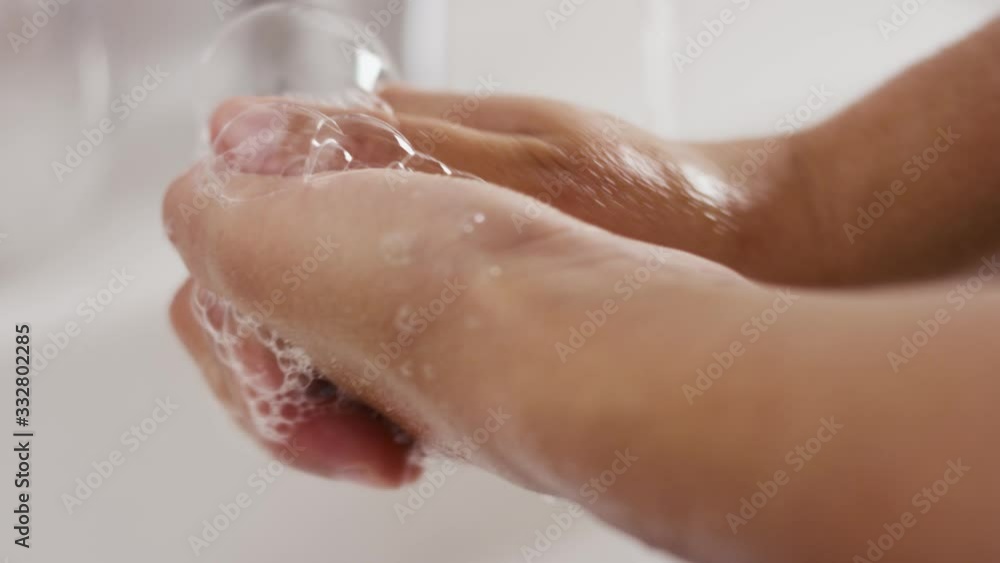 Washing hands in slow motion. rubbing and lathering with soap. Close up Washing hands in slow motion. rubbing and lathering with soap. Close up