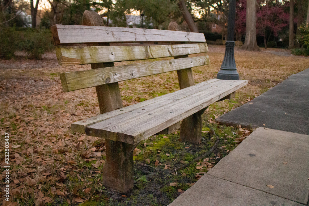 Empty wooden bench in a park on autumn Empty wooden bench in a park on autumn